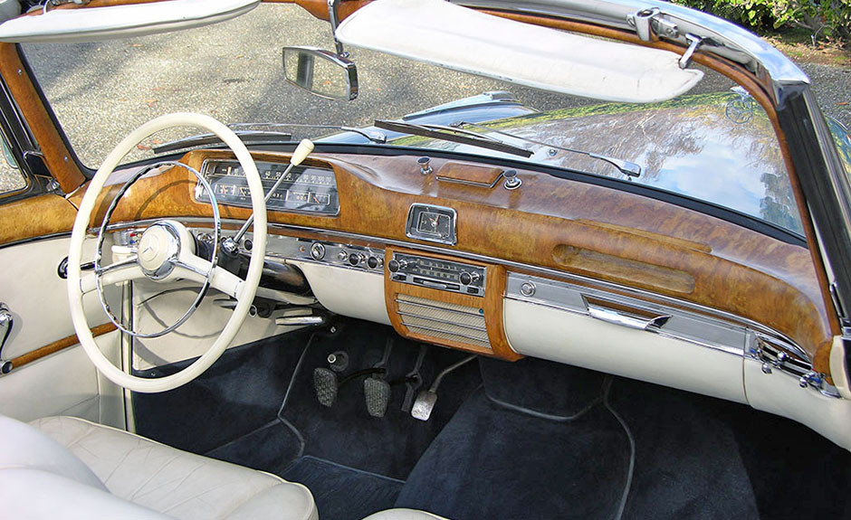 1954 220s dash ergonomically challenging. Massive wood panel anathema today for safety reasons.