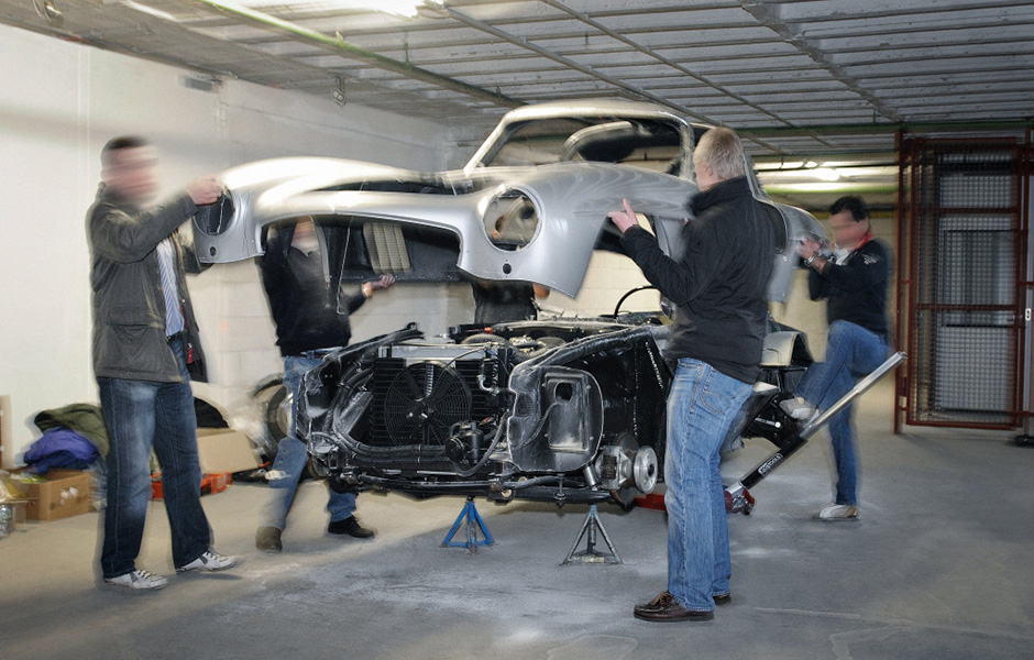 Is this the moment of truth in a Gullwing restoration when the body is once again joined to its chassis? Not quite. We're looking at the bowels of the Mercedes-Benz Used Parts Center and this particular Gullwing body is being crudely removed from its chassis to be crushed and disposed of. 